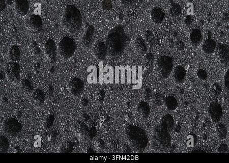 Macro texture black foam sponge with porous surface details Stock Photo