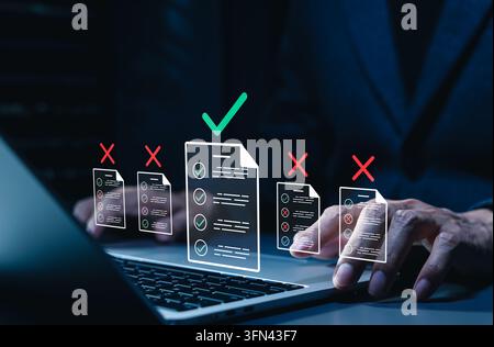 Document evaluation and quality approval audit concept. Businessman typing on laptop with icons of file checklists, green approved checkmark, red reje Stock Photo