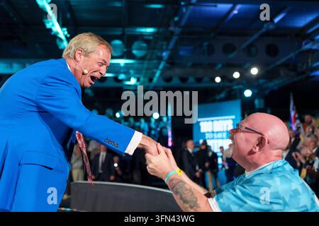 Reform UK leader Nigel Farage greets a supporter at the Reform UK First 100 Days rally, in Doncaster, South Yorkshire. Picture date: Thursday October 1, 2026. Stock Photo