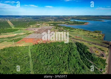Aerial view of an electrical substation beside Itaipu Dam in Brazil, with switchyard equipment, transmission pylons and power lines. Stock Photo