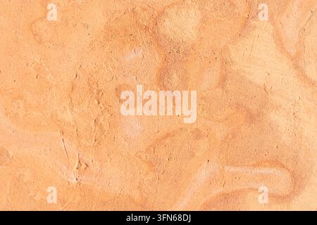 A natural clay tile surface with a rough texture and warm earth tones ranging from orange to brown Stock Photo
