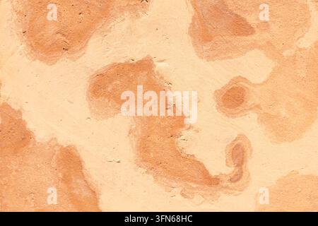 Natural, handcrafted tile with abstract patterns in shades of orange and beige and a rough texture Stock Photo