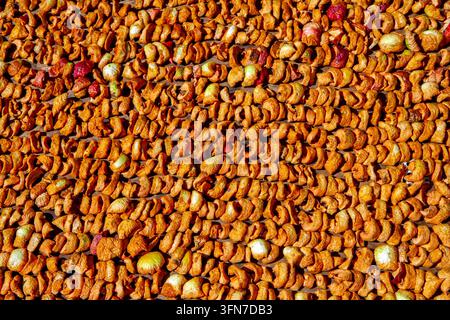 Slices of natural apples are dried for canning. Lots of dried fruits. Stock Photo