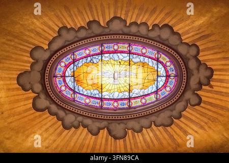 Stained-glass ceiling window depicting the Holy Spirit (dove) surrounded by celestial light & clouds, Cathedral Church of Saint Nicholas, Saborna crkv Stock Photo