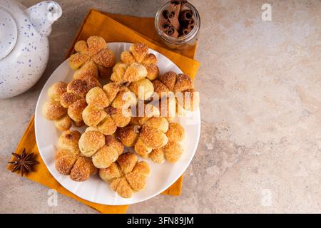 Pumpkin spice buns with almond nuts, cinnamon and sugar crunch. Autumn baking idea, pumpkin puree based vegetable rolls in form of small pumpkins. Tin Stock Photo