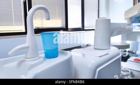 Dental unit water system with blue cup in modern clinic close up Stock Photo