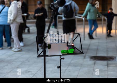 Espoo, Finland - October, 1st, 2026: A music stand with a microphone and handwritten Finnish lyrics on paper is placed outdoors during the Meritie str Stock Photo
