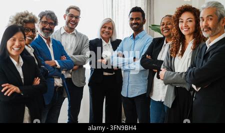 Multigenerational business people smiling on camera inside bank office - Corporate and financial meeting concept - Main focus on indian man face - UGC Stock Photo
