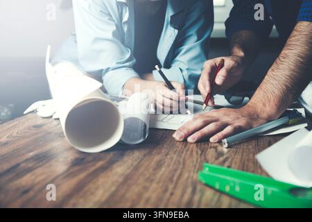 Team of architects working on construction plans Stock Photo