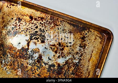 Dirty stained cookie sheet aluminum baking pan bakeware cleaning concept. Stock Photo