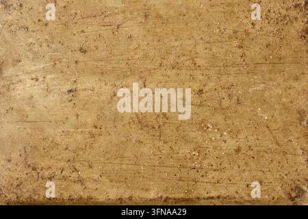 old scratched metal surface texture, rusty brown and golden brass material with grunge pattern in close-up view, industrial design backdrop Stock Photo