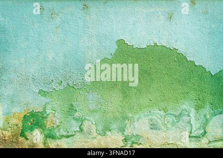Weathered wall with flaking blue and green paint layers. Ideal background for rustic design projects, vintage textures, and urban decay concepts. Stock Photo