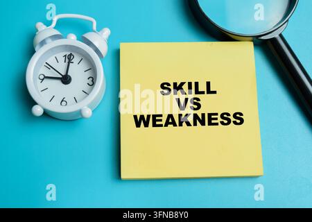 Concept of skill vs weakness write on sticky notes isolated on table. Stock Photo