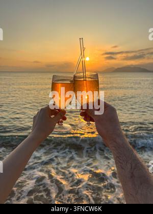 Two hands holding glasses of sparkling wine Stock Photo