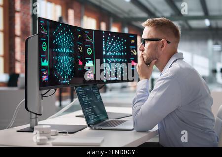 Data Scientist Carefully Codes Neural Network Models On Laptop, Analyzing Data. Stock Photo