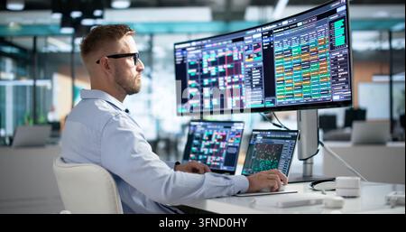 Cybersecurity Engineer Carefully Monitors Real-time Threat Alerts On Ultrawide Screen. Stock Photo