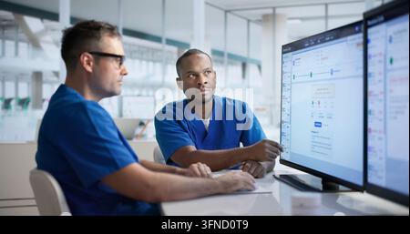 Healthcare Revenue Manager Carefully Reviews Medical Billing Codes On Computer. Stock Photo