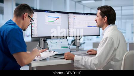 Healthcare Manager Carefully Reviews Medical Billing Claims On Laptop Screen. Stock Photo