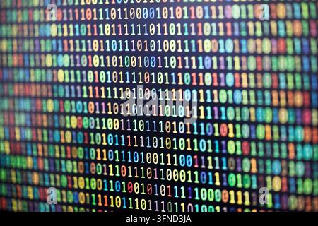 Colorful binary code background on computer screen Stock Photo