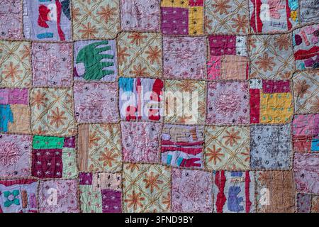 Detail old colorful patchwork carpet in background, India. Close up Stock Photo