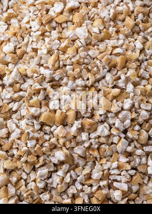 Macro texture of barley groats crushed grains filling full frame, top view, natural food background Stock Photo