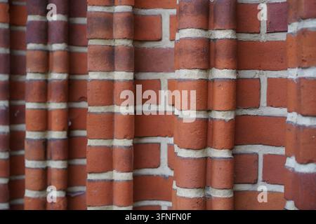 Abstract texture and pattern of a historic red brick wall featuring structured columns and light mortar on the Pankow Village in Berlin, Germany. Stock Photo
