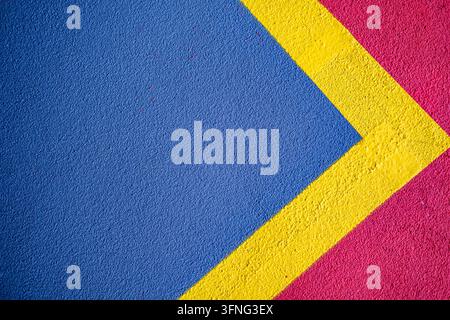 London, UK, October 03 2026, Abstract Geometric Car Park Floor Markings With Bold Blue, Yellow And Pink Paint On Asphalt Stock Photo