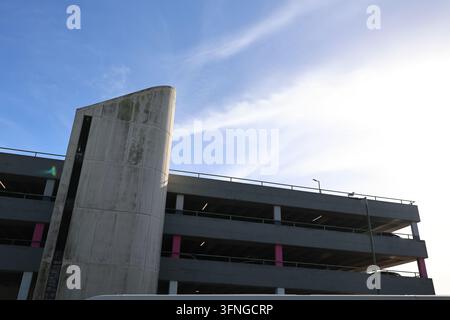 Concrete architectural structure beneath a dramatic blue and white sky. Stock Photo