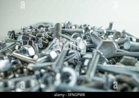 Close up view of various metal fasteners in a large disorganized pile Stock Photo