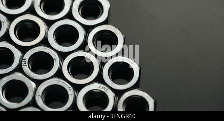 Steel nuts creating a honeycomb pattern, symbolizing connection and engineering Stock Photo