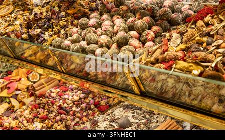 Flowering Tea Balls and Herbal Blends Displayed in Glass Market Containers Stock Photo