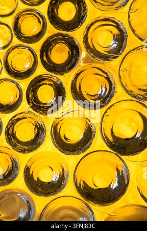 Closeup macro photograph of a handmade yellow glass plate featuring raised circular bumps and textured 3D rings, captured with digital photography usi Stock Photo