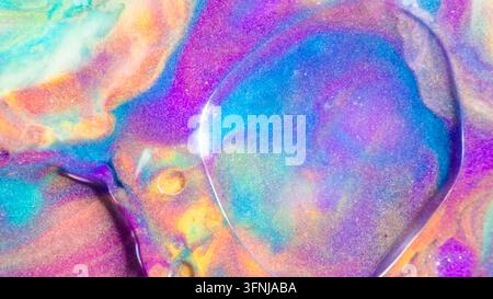 Vibrant abstract background featuring swirling liquid pigments in turquoise, purple, pink, orange, and yellow, with glossy translucent bubbles and shi Stock Photo
