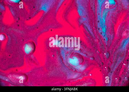 Vibrant abstract background of swirling pink, magenta, purple, and turquoise liquid paint, with glossy bubbles and marbled textures creating a colorfu Stock Photo