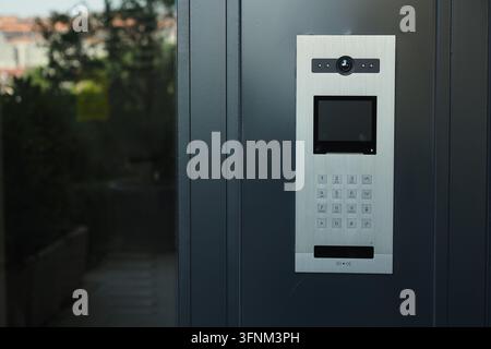 Door intercom system located outside a building entrance with number pad Stock Photo
