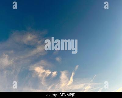 Wispy clouds against a deep blue sky. Stock Photo