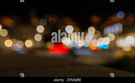 Colorful defocused city lights creating soft circular bokeh at night Stock Photo