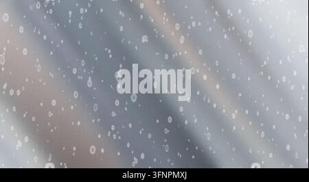 Abstract silver and grey metallic wavy background with soft lighting gradients and floating dust particles or water droplets. Stock Photo