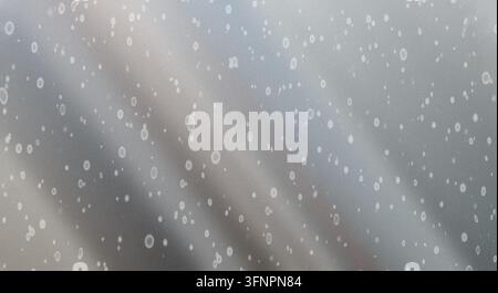 Abstract silver metallic surface texture covered with various circular spots, light gradients, and subtle noise grain pattern. Stock Photo