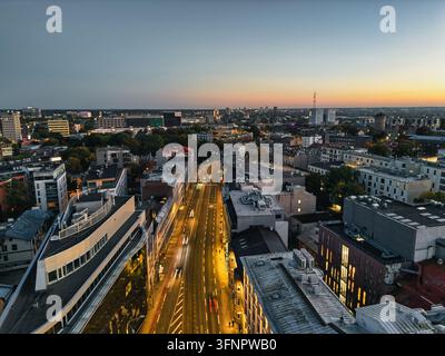 Drone View of City Avenue with Street Lights and Car Light Trails at Dusk Stock Photo