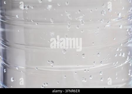 Macro close up view of condensation water droplets on transparent plastic bottle surface with ridged texture Stock Photo