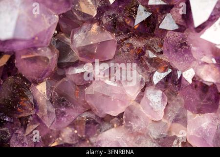Pale purple amethyst crystals form a detailed natural mineral pattern. Stock Photo
