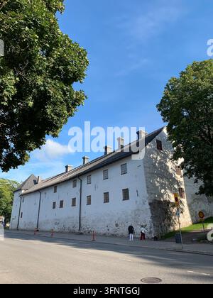 A historic white stone building in Turku, Finland, with a sloped roof featuring multiple chimneys. The facade is punctuated by small rectangular windo Stock Photo