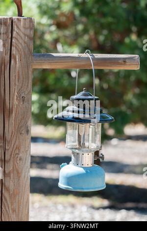 Vintage Blue Camping Lantern Hanging From Wooden Post Stock Photo