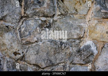 Ancient Rough Stone Wall with Mortar and Fossils – Historic Grunge Rock Texture Background Stock Photo