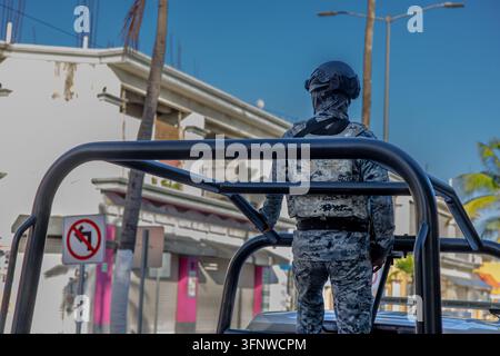 Unrecognizable Armed Mexican Military Soldier in Camouflage Standing on Patrol Vehicle – Urban Security Street Scene Stock Photo