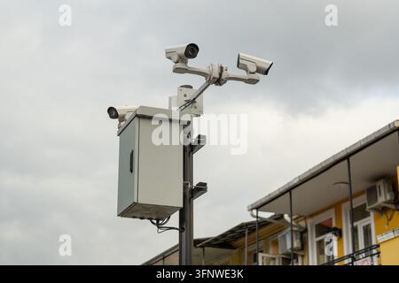 AI-powered video surveillance cameras mounted on city pole for control and safety in public space. Stock Photo