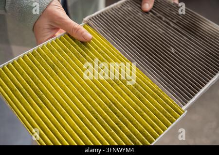 Filte Image A woman compares old and new cabin air filters Stock Photo - Alamy