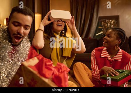 Diverse Friends Watching Asian Woman Using Vr Headset at Party Stock Photo