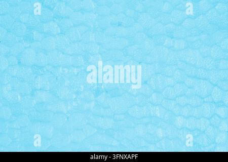 Detailed background texture of light blue expanded polystyrene foam block with soft granular cell structure for packaging or insulation mockup. Stock Photo
